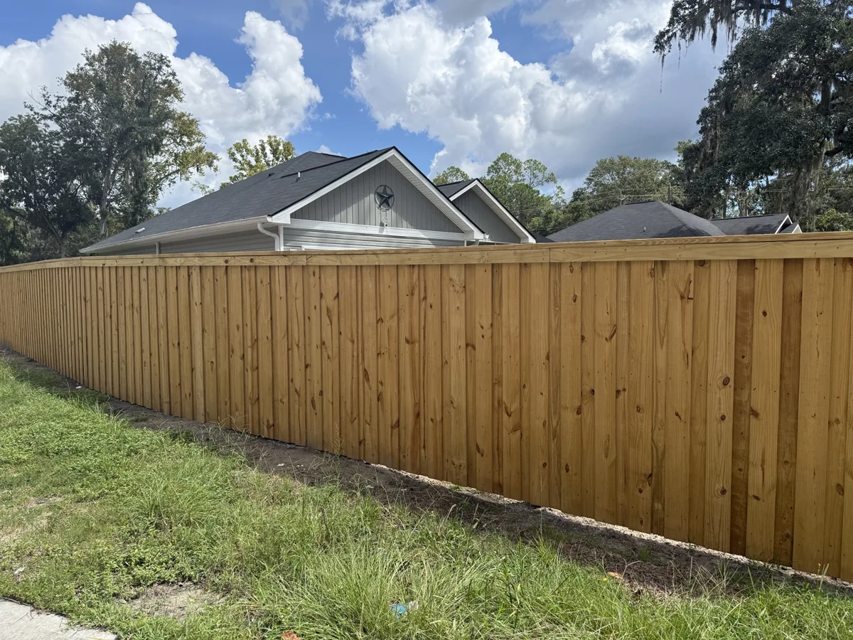 Board-on-board cap-and-trim wood privacy fence installed in Walthourville, Georgia